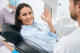 Smiling dental patient making OK sign
