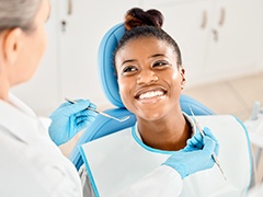 Woman smiling at dentist during exam