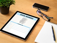 Dental insurance form on desk with supplies