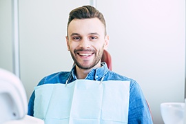 Man smiling while sitting in treatment chair