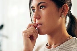 Closeup of woman biting her nails