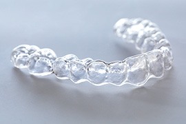 Clear aligner lying on gray surface