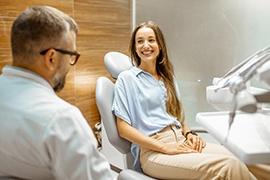 a dentist sitting down and consulting with a patient