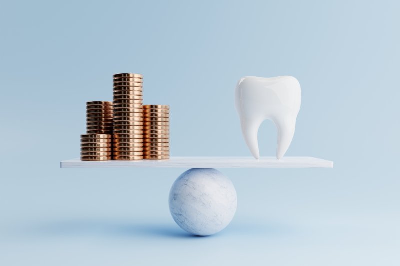 Artificial tooth balanced against stack of coins